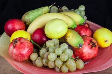 pomegranates and other fruits in a bowl