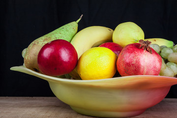 pomegranates and other fruits in a bowl