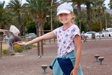 Young girl with a pigeon on the Canary Islands, Fuerteventura- Morro Jable