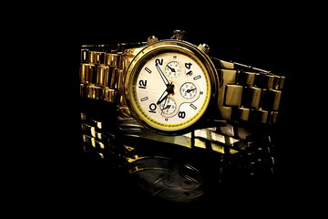 gold watch with reflection