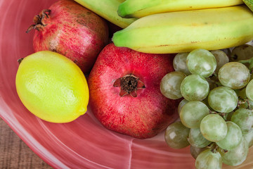 pomegranates and other fruits in a bowl