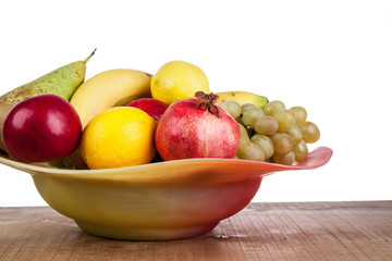 pomegranates and other fruits in a bowl