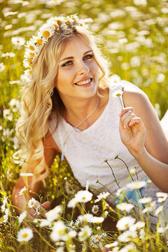 beautiful blonde in a chamomile field