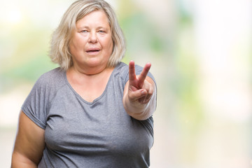 Senior plus size caucasian woman over isolated background smiling looking to the camera showing fingers doing victory sign. Number two.