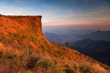 Fototapeta premium Sunset scene with the peak of mountain and cloudscape at Phu chi fa in Chiang rai, Thailand