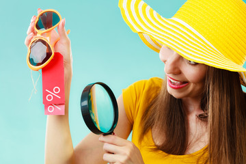 woman choosing glasses searching through magnifying glass