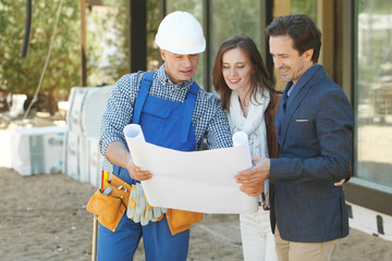 Worker shows house design plans