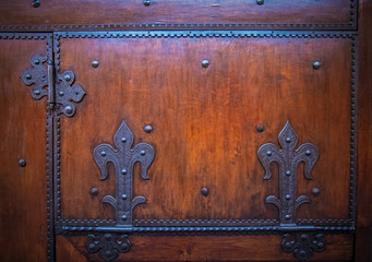 forged metal lily ornament on wooden surface