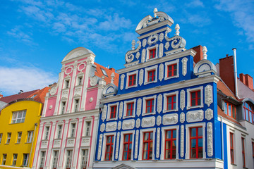 beautiful pastel colorful  houses in old town szczecin, poland against blue sky 