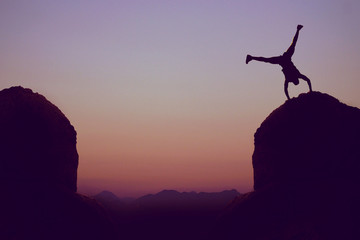 Sporty gymnast in mountains as symbol for fun
