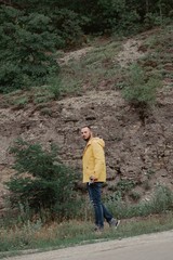Fototapeta premium a man in a yellow raincoat with a camera