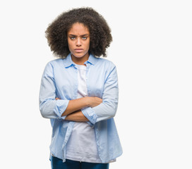 Young afro american woman over isolated background skeptic and nervous, disapproving expression on face with crossed arms. Negative person.