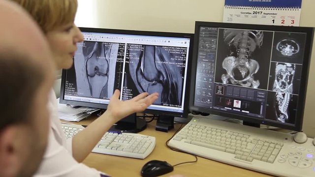 Two doctors discuss the results of computed tomography