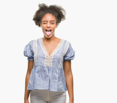 Young afro american woman over isolated background sticking tongue out happy with funny expression. Emotion concept.