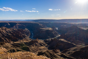 Fototapeta na wymiar fishriver canyon clouds sun blue sky namibia africa