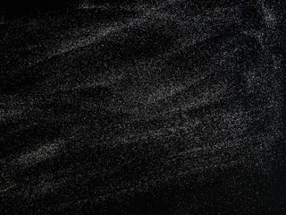 Blurred background lights. Abstract defocused white glitters texture on black background. Shining glowing snow effects