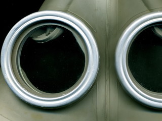 Old Soviet green gas mask. The eye of an old gas mask. postapocalypse.