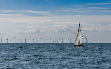 Obraz premium Sailing boat on the background of wind craft park