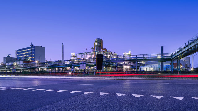 Illuminated petrochemical production plant at twilight, Port of Antwerp, Belgium.