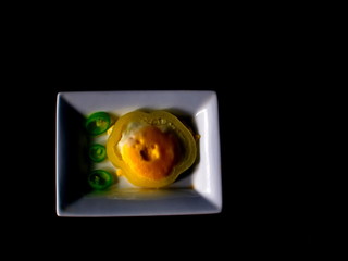 fried eggs with bitter green pepper on a plate.