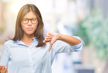 Young asian business woman over isolated background holding clipboard with angry face, negative sign showing dislike with thumbs down, rejection concept