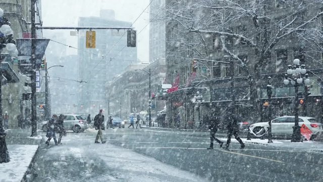 People Cross City Road In Snowstorm