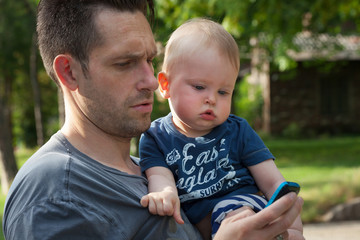 Father and son looking at a mobile phone