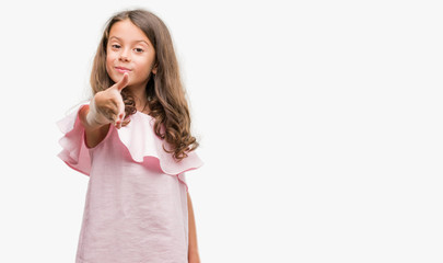 Brunette hispanic girl wearing pink dress smiling friendly offering handshake as greeting and welcoming. Successful business.