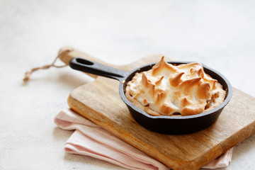 Homemade apple meringue pie in cust iron fry pan copy space