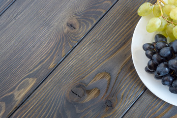 grapes on a wooden background black wax