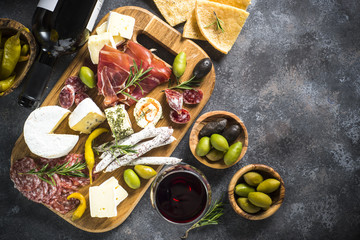 Antipasto board with sliced meat, ham, salami, cheese, olives an