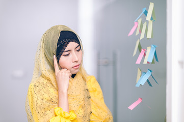 Arab women business thinking something on sticky notes in a meeting room at office