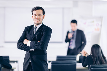 Successful Cooperation Organization Peoplel !Beautiful Businessman standing and cross one's arm in conference room.Meeting room for analyzing charts and graphs