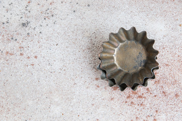 Vintage metal molds on a concrete background.