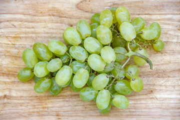 Bunch of grapes on a wooden board