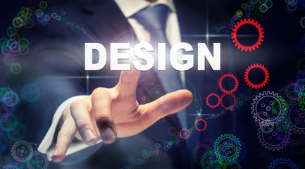A businessman pressing a Design business concept on a graphical display of cogs