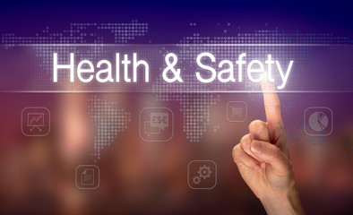 A hand selecting a Health And Safety business concept on a clear screen with a colorful blurred background.