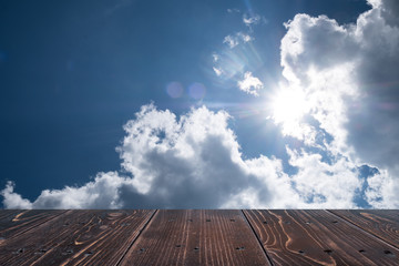 Dark brown wooden table on front beautiful cloudy background, for presentation product
