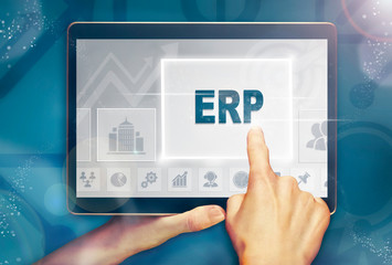 A hand selecting a ERP business concept on a clear screen with a colorful blurred background.