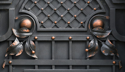 Wrought-iron gates, ornamental forging, forged elements close-up.