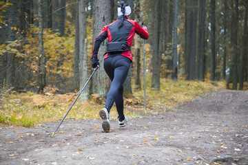 woman practicing nordic walking in nature