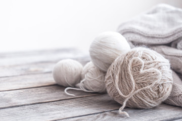 Fototapeta na wymiar home hobbies, knitting threads a wooden background