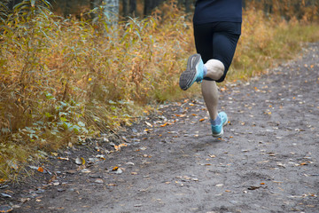 running on the street in the autumn Park