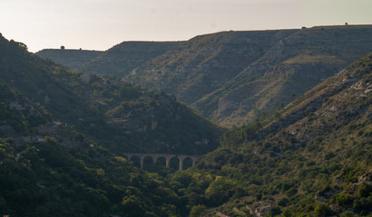 Fototapeta na wymiar ancient bridge in the mountains ragusa sicily