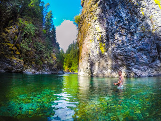 Young Beautiful Woman Swims in Crystal Clear Green River Mermaid