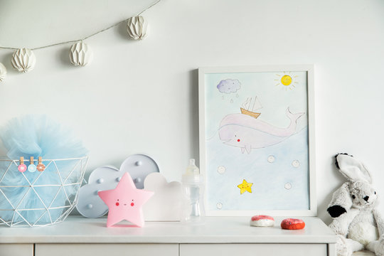 The modern scandinavian newborn baby room with mock up poster frame, white clouds, pink star, white rabbit and cotton lamps . 