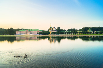 Fototapeta premium Evening serenity of the palace pond, included into ensemble of the State reserve museum Kuskovo, former aristocratic summer country estate of the russian nobility of the 18th century. Moscow. Russia.