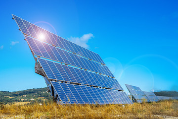Solar farm. Solar power station with blue sky. Solar panels on the hill. Concept eco life. Concept...