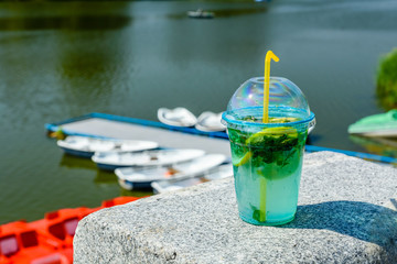 Mojito cocktail on a granite parapet with river on background