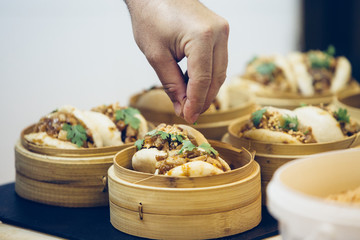 Detail of the hand of a chef preparing spanish tapas